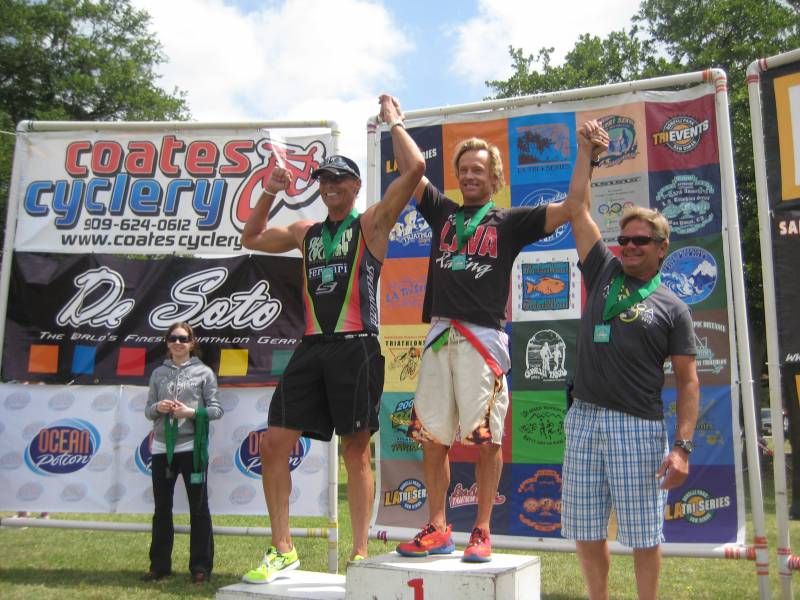Athletes posing at cycling event podium