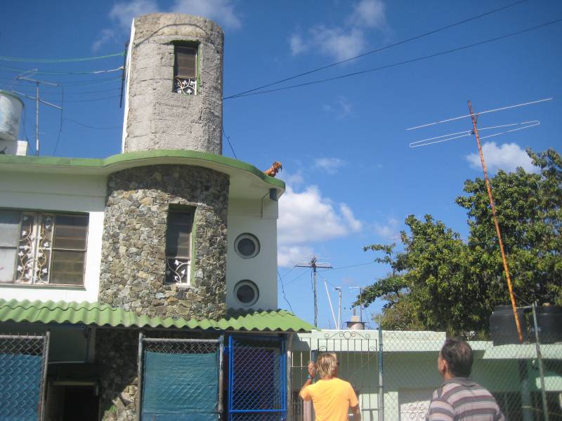 Rooster perched on stone building