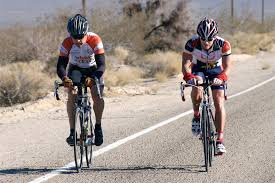 Road cyclists in dry, open terrain